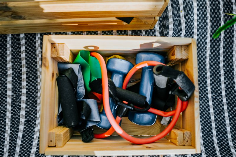 DIY wooden box filled with colorful small gym equipment (Photo by Carol Yepes/Moment via Getty Images)